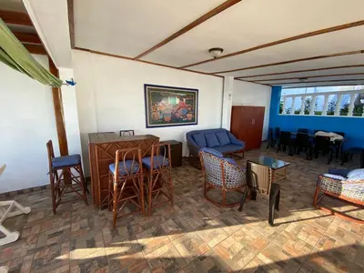 a living room with chairs and a couch and a table at Mar y Cielo Beach House in Tamanique