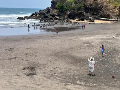 a group of people standing on a beach at Mar y Cielo Beach House in Tamanique