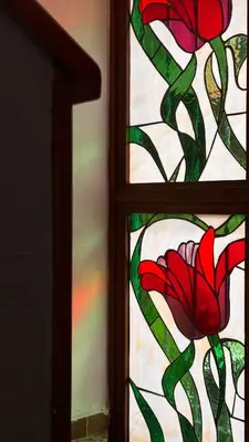 a stained glass window with a red flower on it at Artful and Quiet Pause in Santa Tecla and BBQ garden in Nueva San Salvador