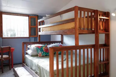 a bedroom with two bunk beds in a room at Artful and Quiet Pause in Santa Tecla and BBQ garden in Nueva San Salvador