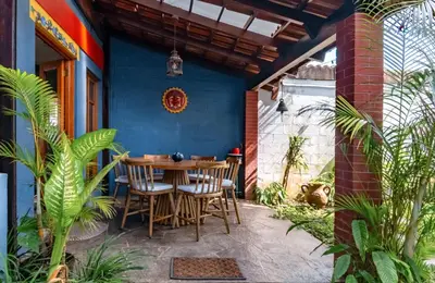 a patio with a wooden table and chairs at Artful and Quiet Pause in Santa Tecla and BBQ garden in Nueva San Salvador