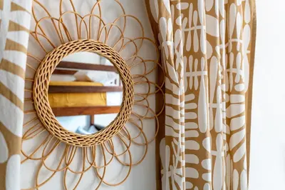 a mirror on a wall next to a curtain at Artful and Quiet Pause in Santa Tecla and BBQ garden in Nueva San Salvador