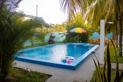 a swimming pool with a toy boat and an umbrella at Coco Cabana en Playa San Diego in San Diego