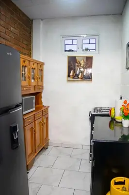 a kitchen with wooden cabinets and a refrigerator at Coco Cabana en Playa San Diego in San Diego