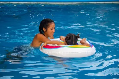 a woman and a child in the water on a raft at Coco Cabana en Playa San Diego in San Diego