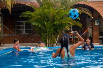 a group of children playing with a soccer ball in a swimming pool at Coco Cabana en Playa San Diego in San Diego