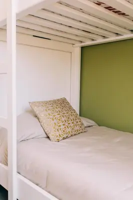 a white bunk bed with a pillow on it at NEW Cozy&Modern Apt 30min from SurfCity in Hacienda Plan de La Laguna