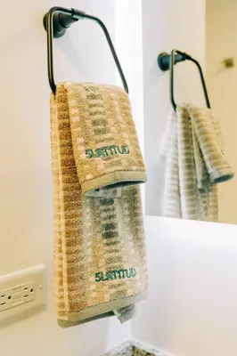 a towel hanging on a towel rack in a bathroom at NEW Cozy&Modern Apt 30min from SurfCity in Hacienda Plan de La Laguna