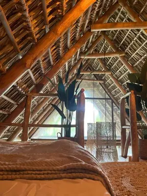 a room with a bed and a large window at hotel nativo san blas in Playa San Blas