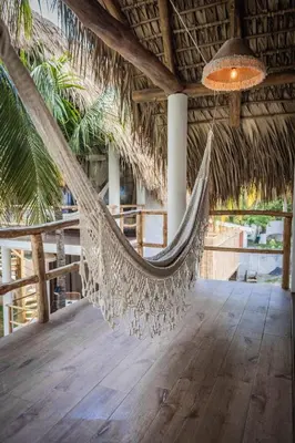 a hammock in a straw hut with a light at hotel nativo san blas in Playa San Blas