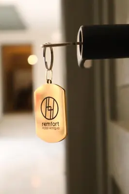 a key tag hanging from a door handle at Remfort Hotel Antigua in Santa Ana