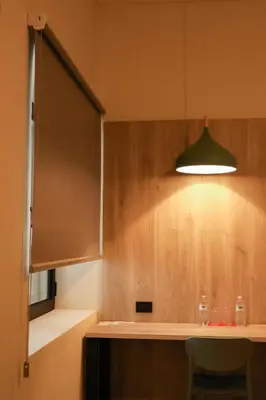 a kitchen with a light hanging over a counter at Remfort Hotel Antigua in Santa Ana