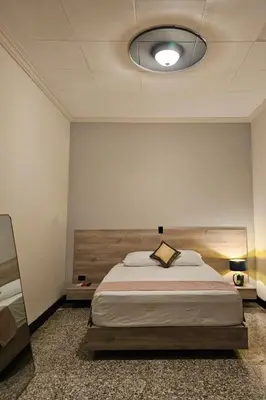 a bedroom with a large bed in a room at Remfort Hotel Antigua in Santa Ana