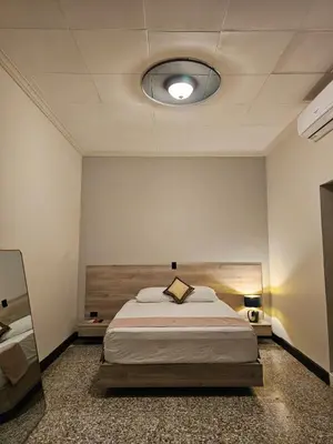 a bedroom with a large bed in a room at Remfort Hotel Antigua in Santa Ana