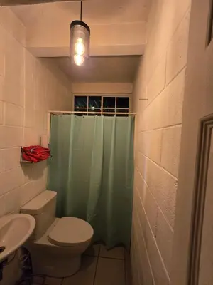 a bathroom with a shower with a toilet and a sink at central and private apartment in Santa Ana
