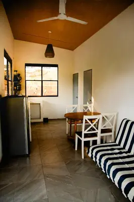 a living room with a table and a chair at Villa Palmarcito in El Zonte