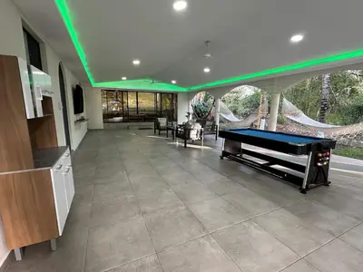 a living room with a pool table in a house at Pool • Game Room • Fire Pit • Resort Access in Los Cóbanos