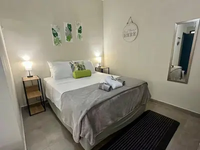 a bedroom with a bed with a green pillow on it at Pool • Game Room • Fire Pit • Resort Access in Los Cóbanos