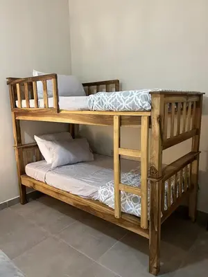 two wooden bunk beds in a room with at Pool • Game Room • Fire Pit • Resort Access in Los Cóbanos