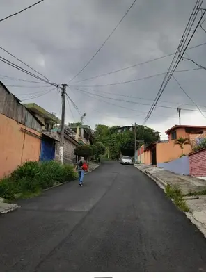 a person walking down a street in a town at Hogar cálido