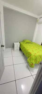 a bedroom with a bed with a yellow comforter at Hogar cálido