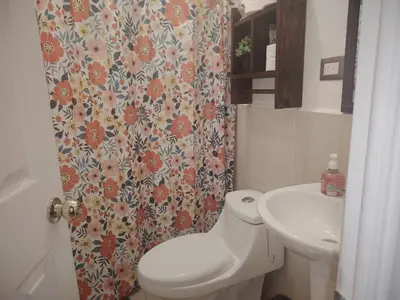 a bathroom with a toilet and a sink at Casa Socorrito in Ahuachapán