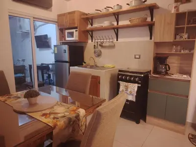 a kitchen with a table and a dining room at Casa Socorrito in Ahuachapán