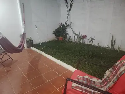 a room with a patio with a yard with plants at Casa Socorrito in Ahuachapán