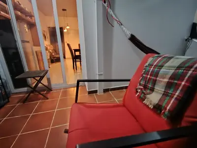 a living room with a red couch and a table at Casa Socorrito in Ahuachapán