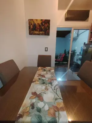a dining room table with a floral table cloth on it at Casa Socorrito in Ahuachapán