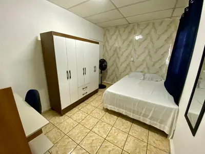 a small bedroom with a bed and a cabinet at Los Poca, Entire Home near Stadiums & Malls, San Salvador in San Salvador