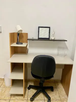 a desk with a chair and a lamp on it at Los Poca, Entire Home near Stadiums & Malls, San Salvador in San Salvador
