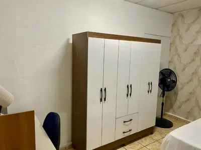 a room with a white cabinet and a fan at Los Poca, Entire Home near Stadiums & Malls, San Salvador in San Salvador