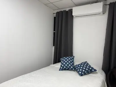 a bedroom with a bed with two pillows on it at Hostal Proceres in San Salvador