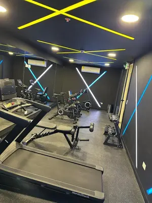 a gym with several treadmills and exercise bikes at NU Lomas Garden in Antiguo Cuscatlán