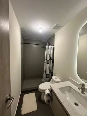 a bathroom with a toilet and a sink and a shower at NU Lomas Garden in Antiguo Cuscatlán