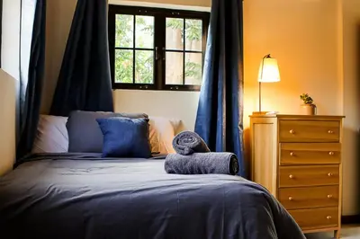 a bedroom with a bed with a stuffed animal on it at Finca La Guayaba, Nature and rural life