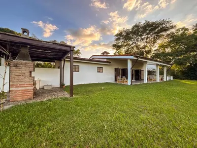 a house with a grassy yard in front of it at Finca La Guayaba, Nature and rural life