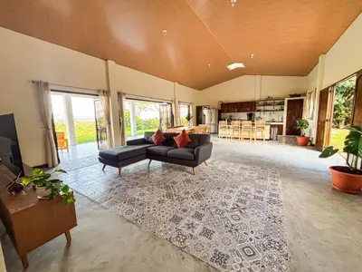 a large living room with two couches and a kitchen at Finca La Guayaba, Nature and rural life