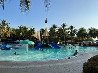 a group of people in a pool at a resort at Game Room • Fire Pit • Pool • Resort Access in Los Cóbanos