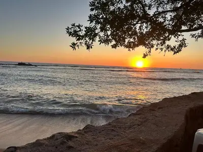 a sunset over the ocean with the sun setting at Game Room • Fire Pit • Pool • Resort Access in Los Cóbanos