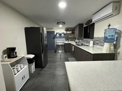 a kitchen with a refrigerator and a counter in it at Game Room • Fire Pit • Pool • Resort Access in Los Cóbanos