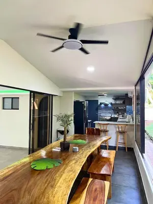 a dining room with a large wooden table with benches at Game Room • Fire Pit • Pool • Resort Access in Los Cóbanos