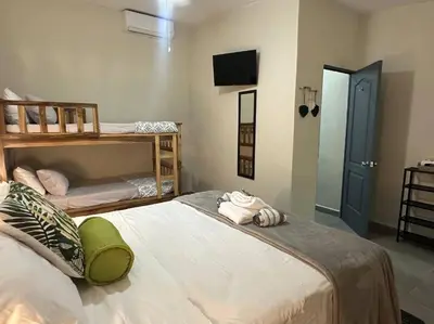 a bedroom with two bunk beds and a tv at Pool • Fire Pit • Game Room • Resort Access in Los Cóbanos