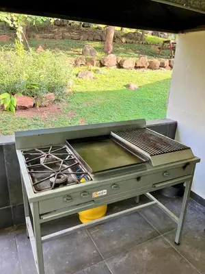 a barbecue grill sitting on a patio with at Pool • Fire Pit • Game Room • Resort Access in Los Cóbanos