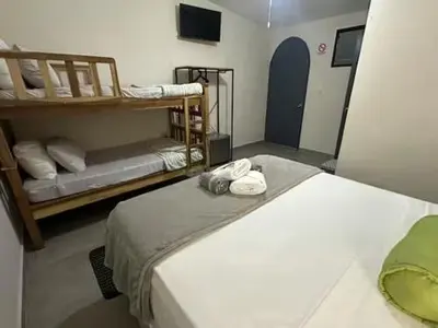 a room with two beds and two bunk beds at Pool • Fire Pit • Game Room • Resort Access in Los Cóbanos