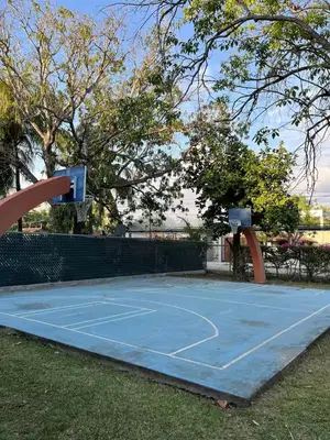 a blue tennis court with a basketball hoop on it at Pool • Fire Pit • Game Room • Resort Access in Los Cóbanos