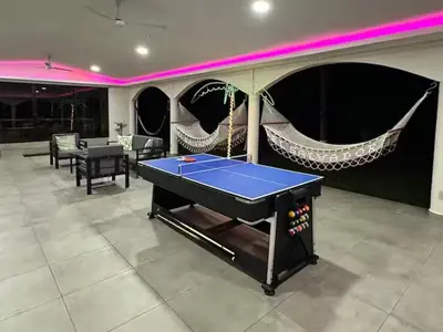 a ping pong table in a room with a ping pong ball at Pool • Fire Pit • Game Room • Resort Access in Los Cóbanos