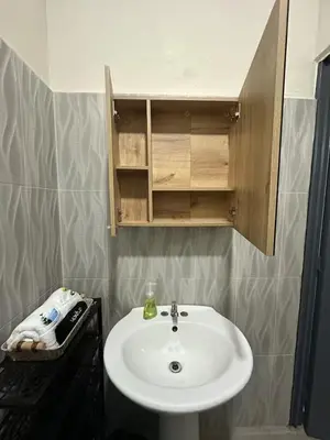 a bathroom with a white sink and a mirror at Pool • Resort Access • Game Room • Fire Pit in Los Cóbanos