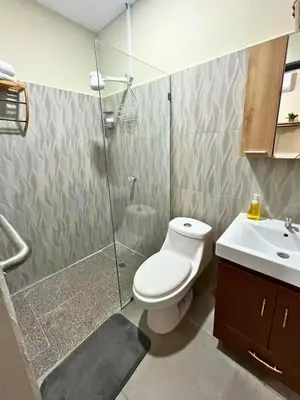 a bathroom with a shower and a toilet and a sink at Pool • Resort Access • Game Room • Fire Pit in Los Cóbanos